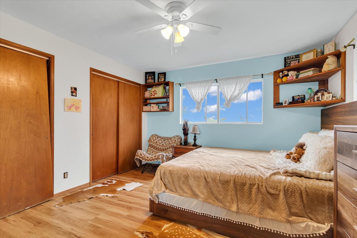 18-4327 North Peck Road Mountain View, HI 96771 - Photo 16 of 26 a bedroom with a bed and a chandelier