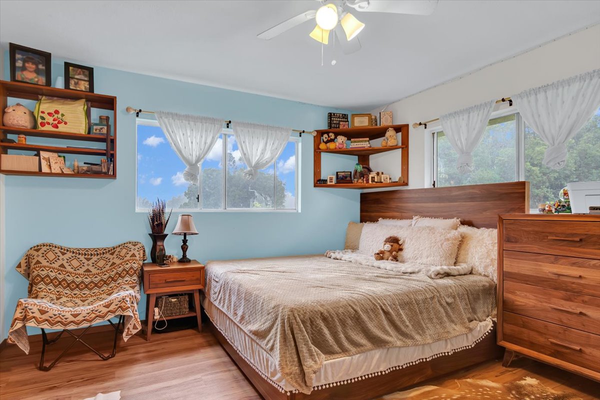 18-4327 North Peck Road Mountain View, HI 96771 - Photo 16 of 30 a bedroom with a bed and wooden floor