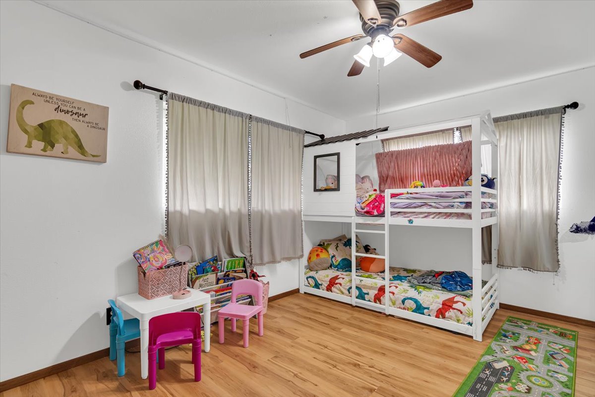 18-4327 North Peck Road Mountain View, HI 96771 - Photo 18 of 26 a bedroom with furniture and a chandelier