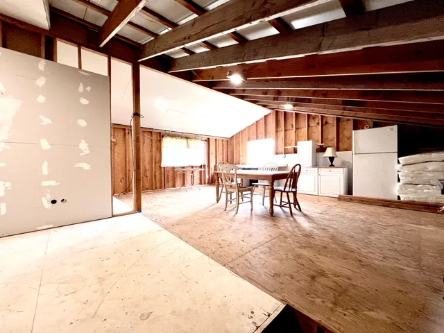 a dining room with furniture and a floor to ceiling window