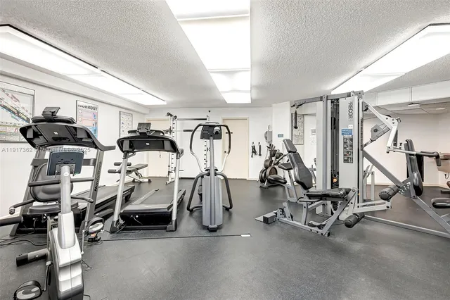 a living room with furniture and view of kitchen