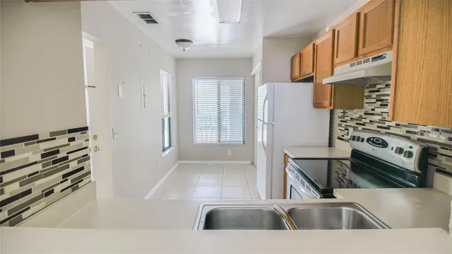 a kitchen with a refrigerator and a sink