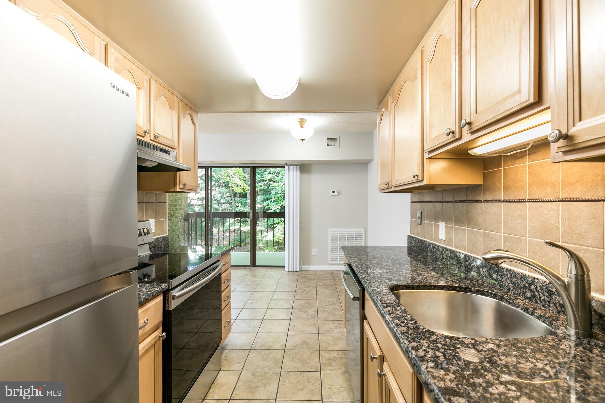 11650 Stoneview Square, Unit 11C Reston, VA 20191 - Photo 2 of 26 a kitchen with granite countertop a sink and a window