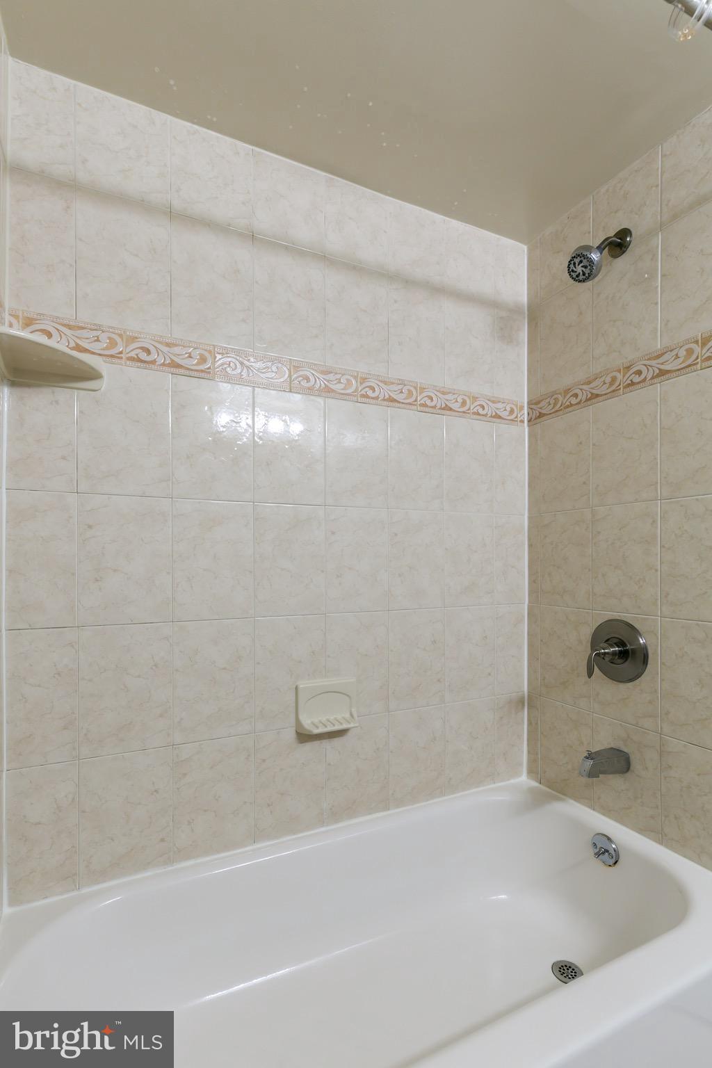11650 Stoneview Square, Unit 11C Reston, VA 20191 - Photo 11 of 26 a bathroom with a shower and a bathtub