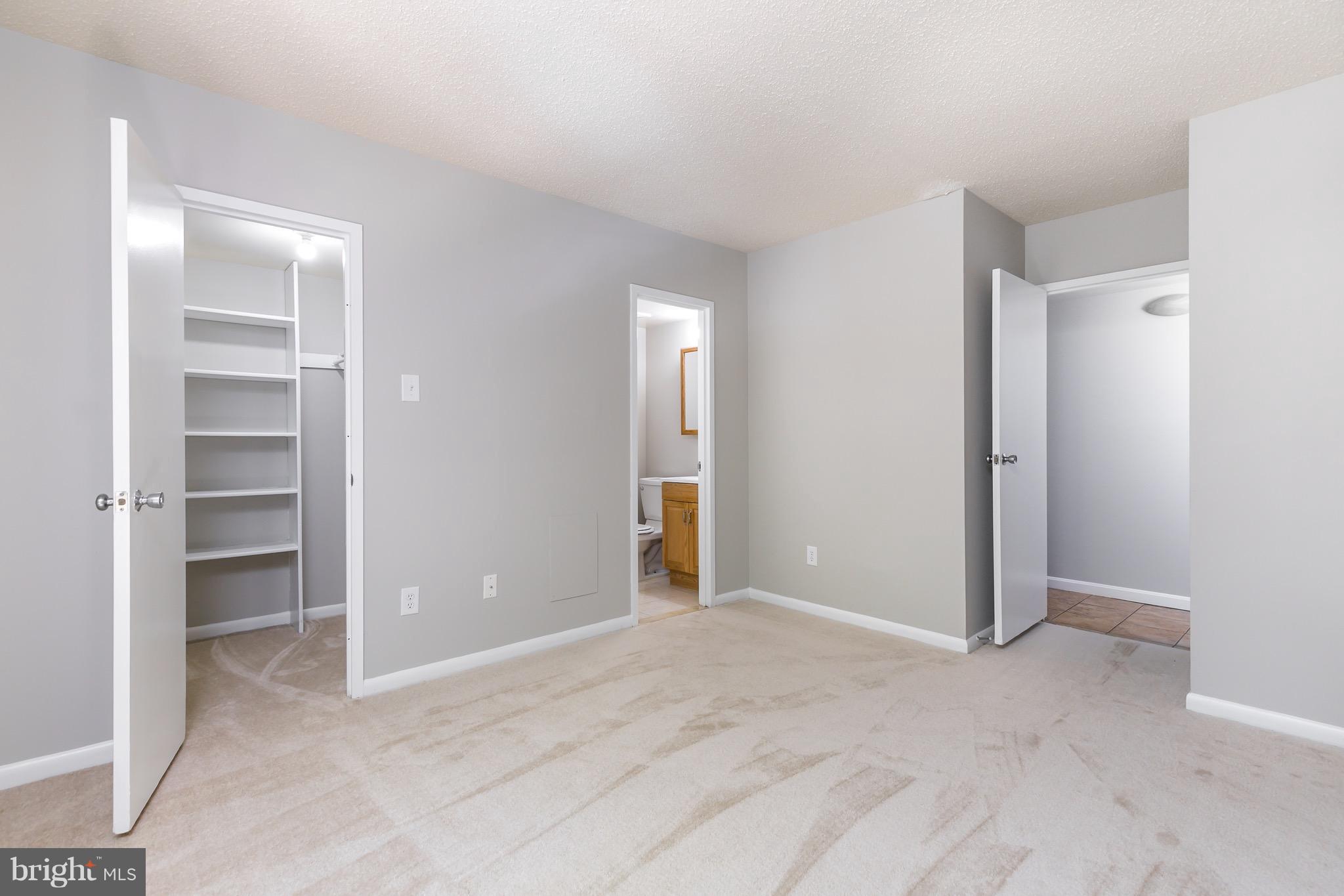 11650 Stoneview Square, Unit 11C Reston, VA 20191 - Photo 14 of 26 an empty room with closet and windows