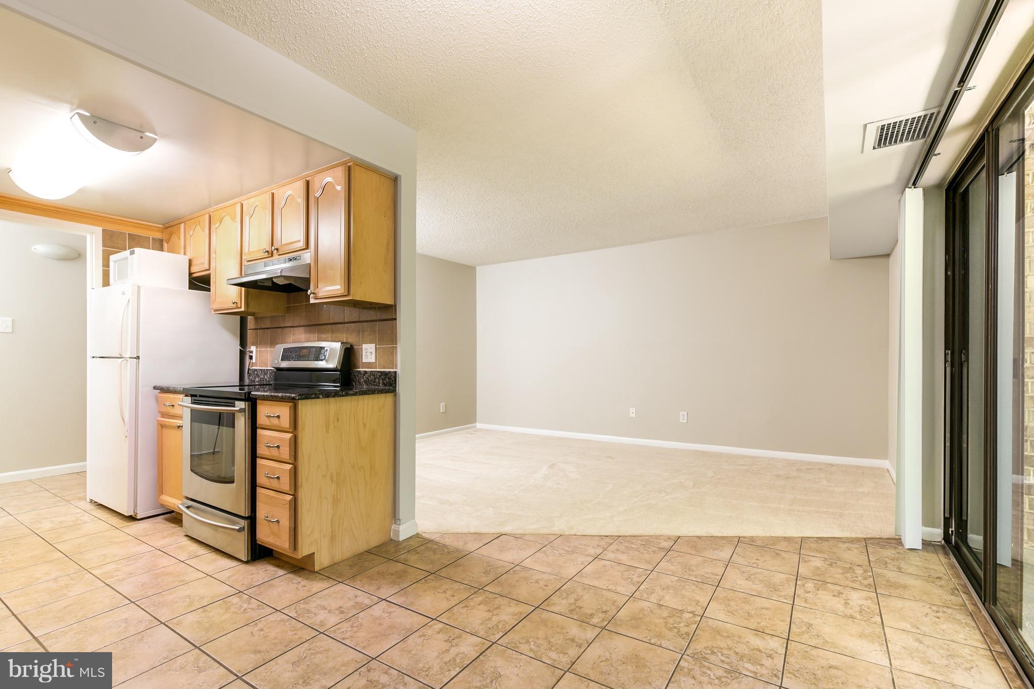 11650 Stoneview Square, Unit 11C Reston, VA 20191 - Photo 19 of 26 a kitchen with refrigerator and window