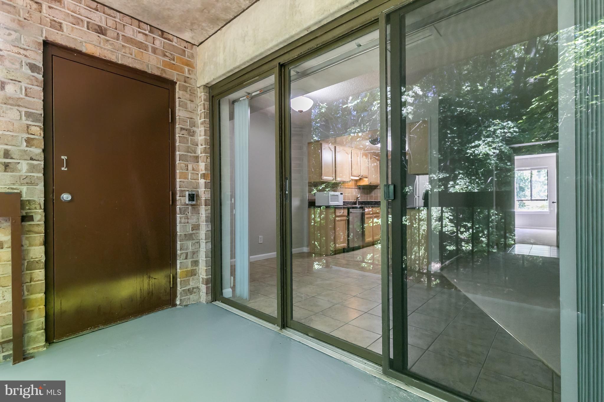 11650 Stoneview Square, Unit 11C Reston, VA 20191 - Photo 21 of 26 a view of a glass door and a living room
