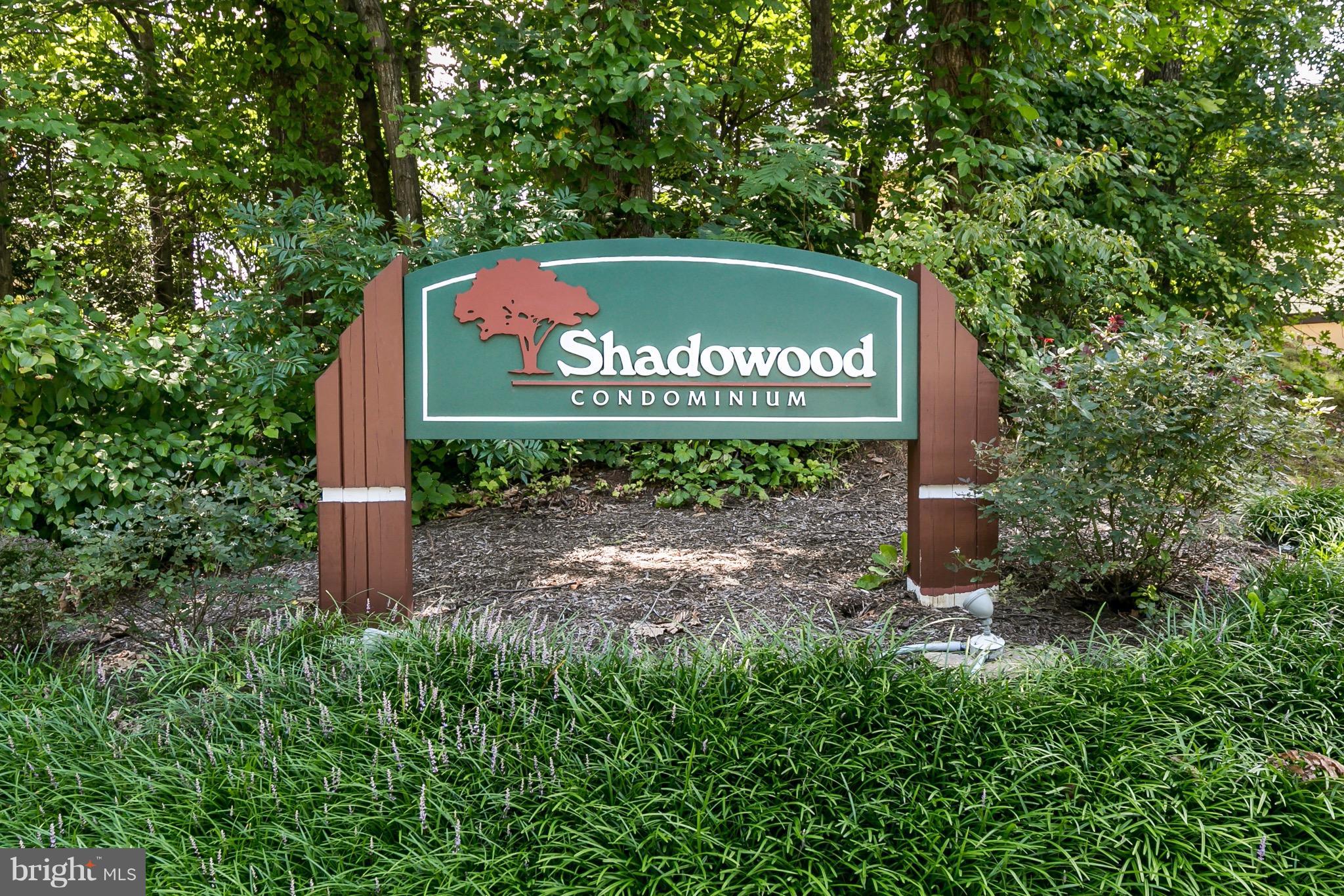 11650 Stoneview Square, Unit 11C Reston, VA 20191 - Photo 24 of 26 a blue sign that is sitting in front of a tree