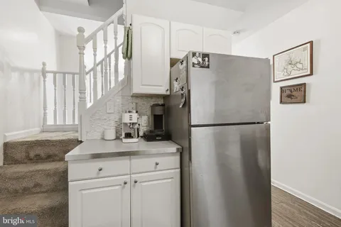 a white refrigerator freezer sitting inside of a kitchen