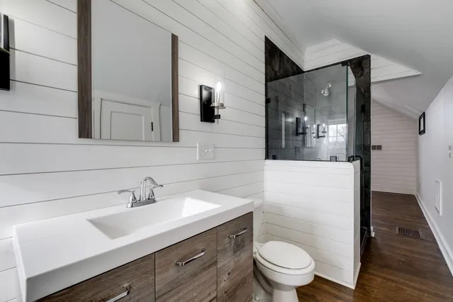 a bathroom with a sink toilet and shower
