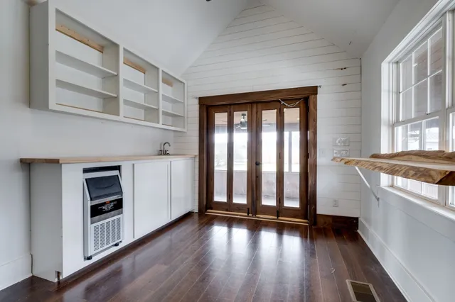 a view of a kitchen with wooden floor and a kitchen