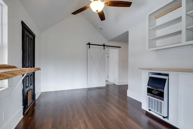 a view of a livingroom with wooden floor and staircase