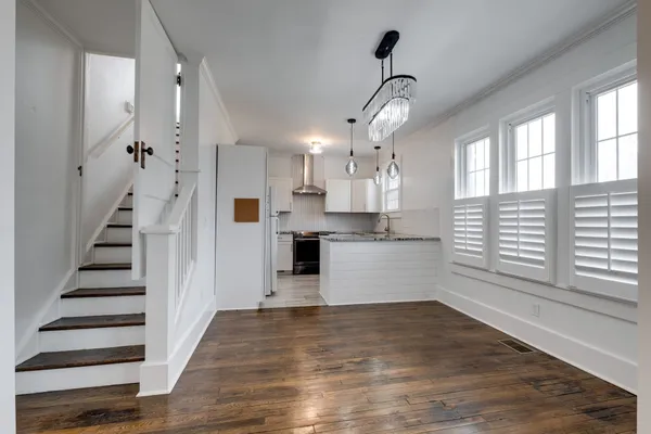 a view of a kitchen with wooden floor and a kitchen