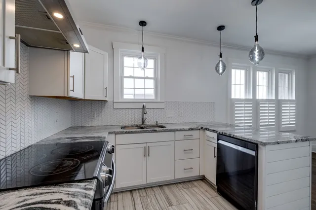 a kitchen with a sink stove and cabinets