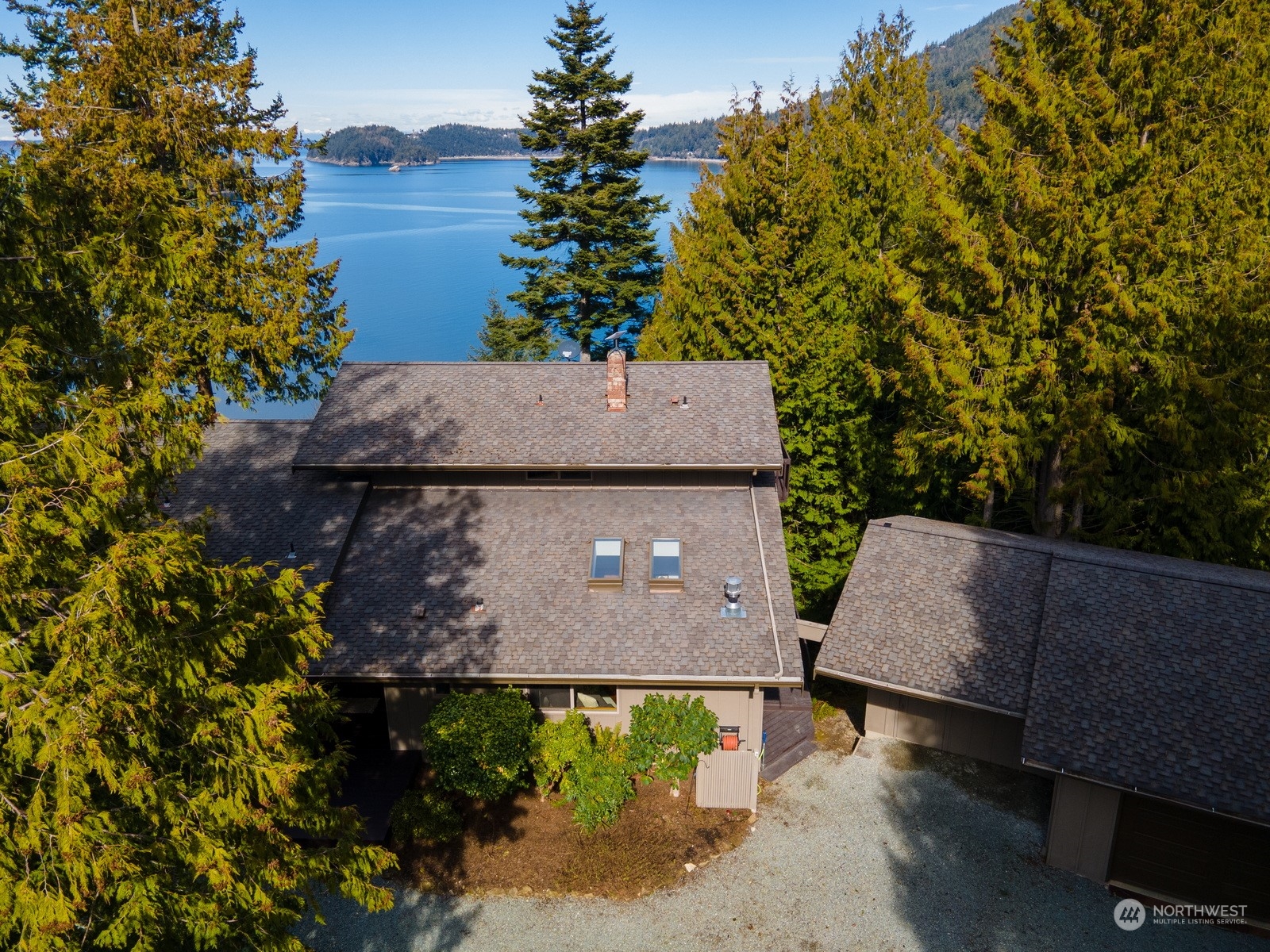 an aerial view of a house with a yard and wooden fence