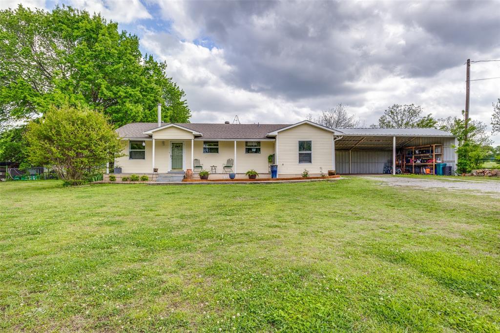 a front view of house with yard and green space