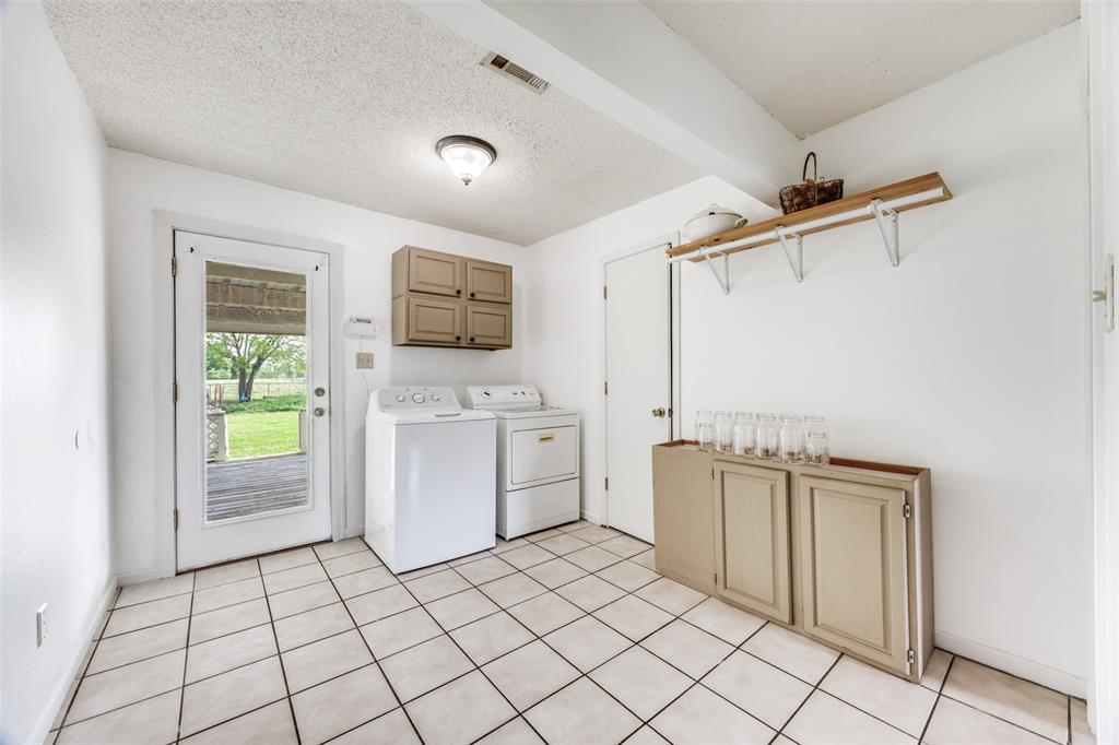 4440 Dripping Spring Road Sherman, TX 75090 - Photo 11 of 39 a utility room with cabinets washer and dryer