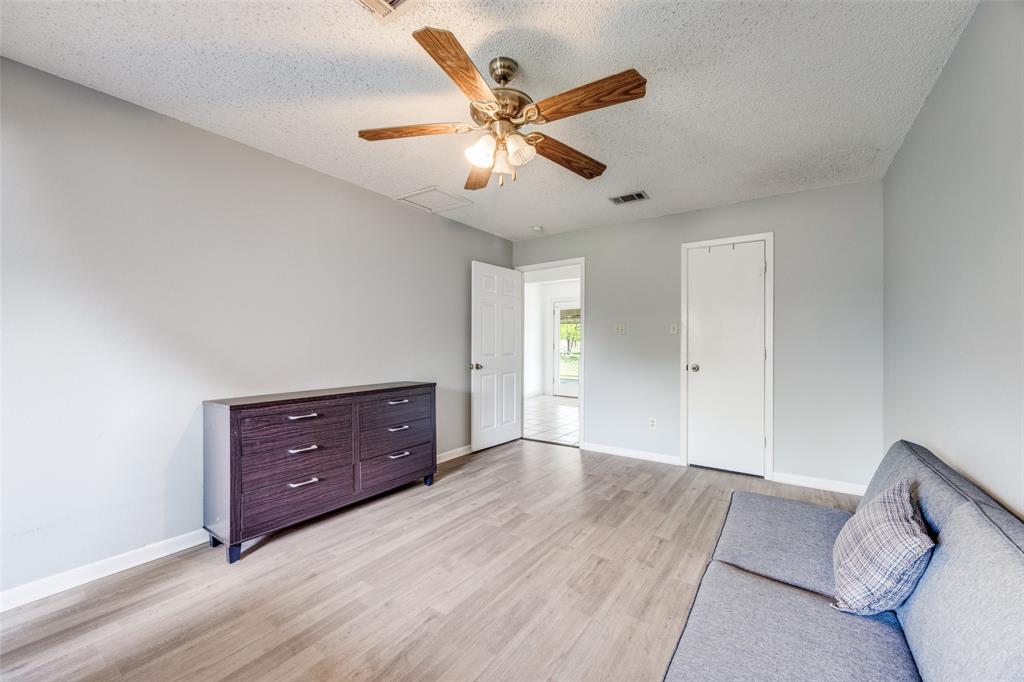 4440 Dripping Spring Road Sherman, TX 75090 - Photo 12 of 39 a view of an empty room with cabinet and a ceiling fan