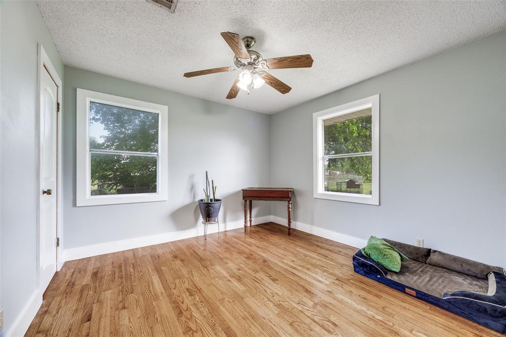 4440 Dripping Spring Road Sherman, TX 75090 - Photo 16 of 39 a workspace with wooden floor and a window