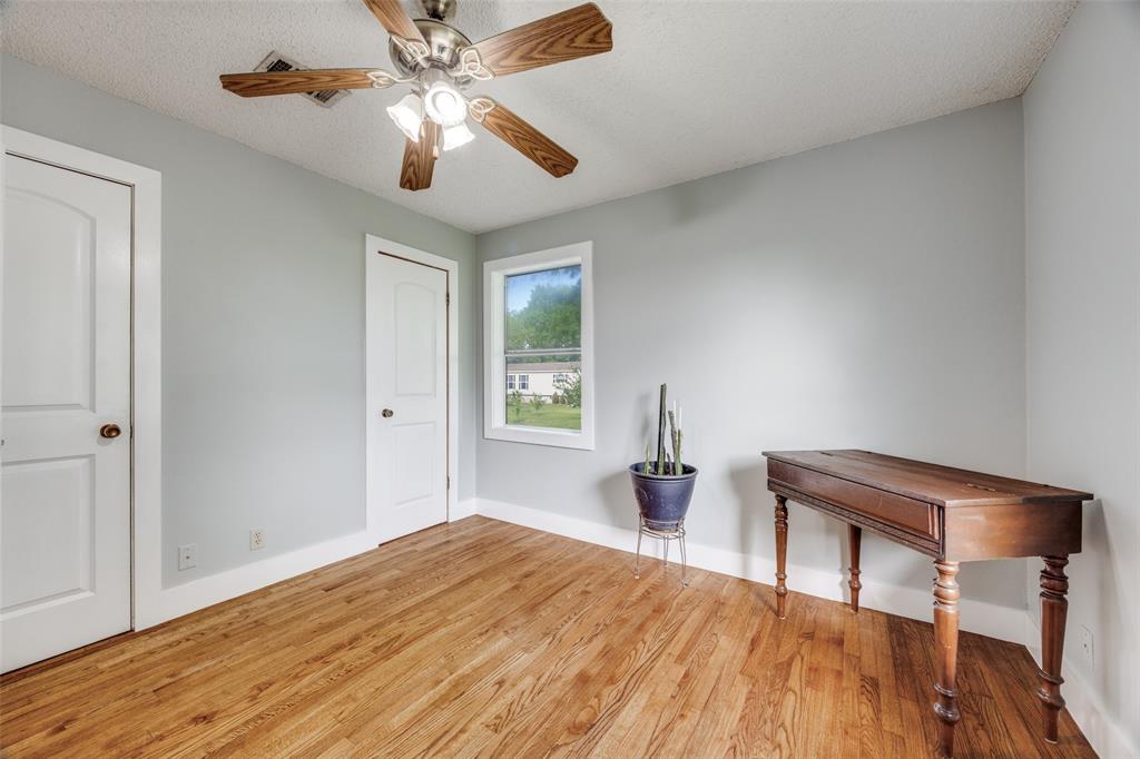 4440 Dripping Spring Road Sherman, TX 75090 - Photo 17 of 39 a bedroom with a bed and a chandelier