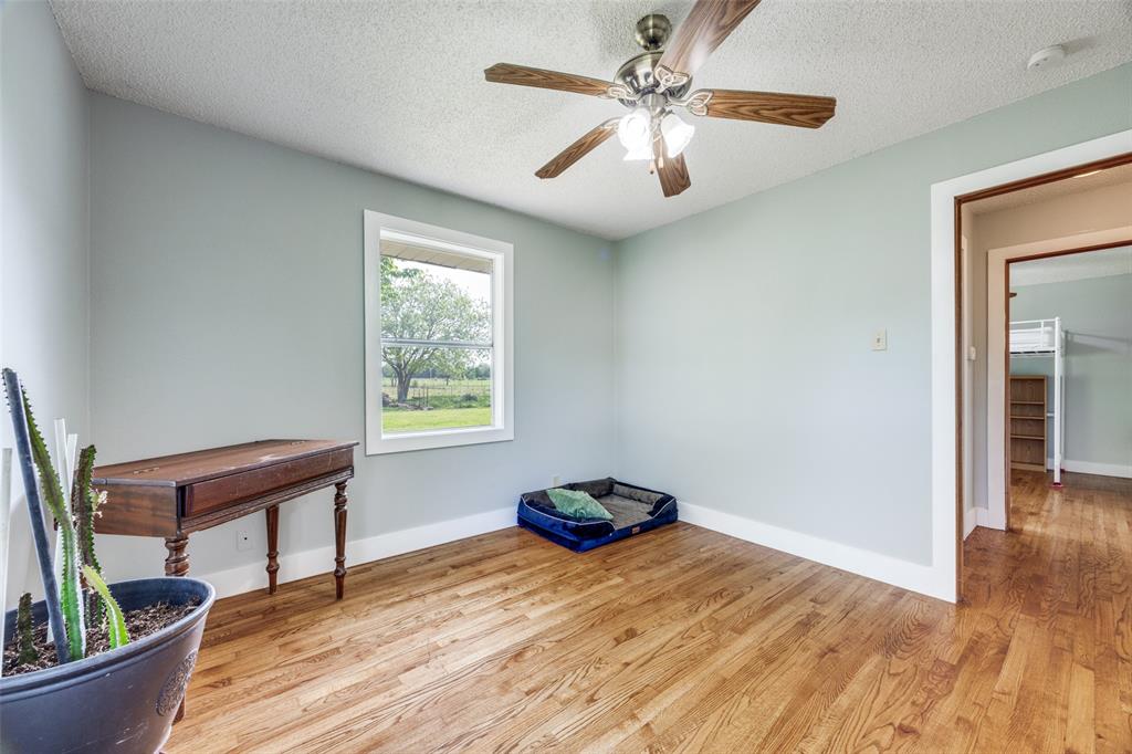 4440 Dripping Spring Road Sherman, TX 75090 - Photo 18 of 39 a bedroom with furniture and a window