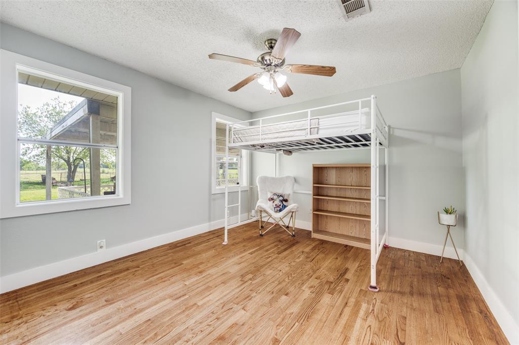 4440 Dripping Spring Road Sherman, TX 75090 - Photo 19 of 39 wooden floor in an empty room with a window