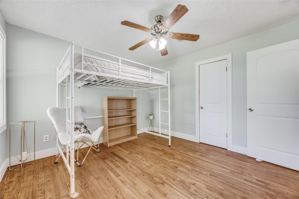 4440 Dripping Spring Road Sherman, TX 75090 - Photo 20 of 39 a view of a livingroom with a chair and wooden floor