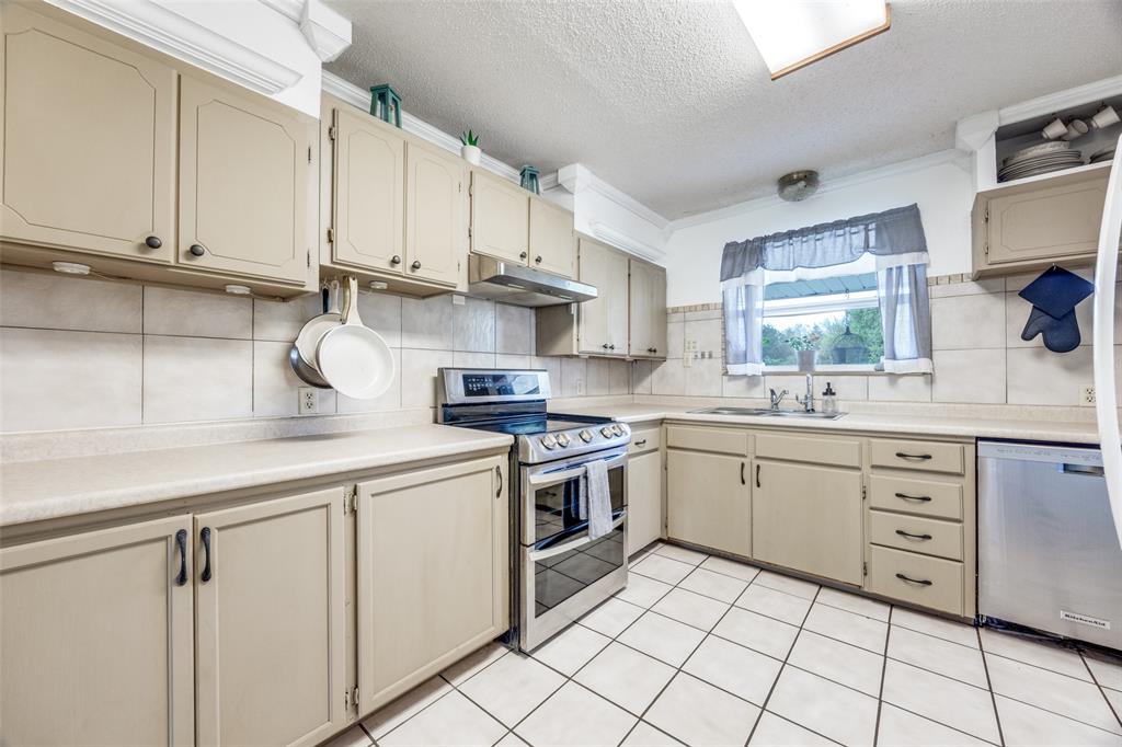 4440 Dripping Spring Road Sherman, TX 75090 - Photo 9 of 39 a kitchen with white cabinets appliances and a sink
