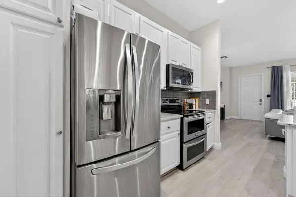 a kitchen with stainless steel appliances a refrigerator stove and microwave