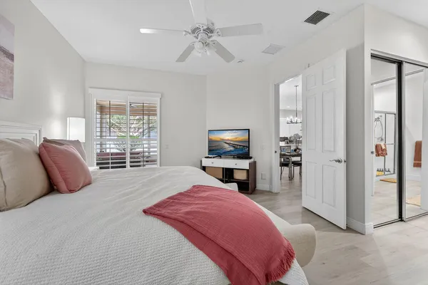 a bedroom with a bed and a television