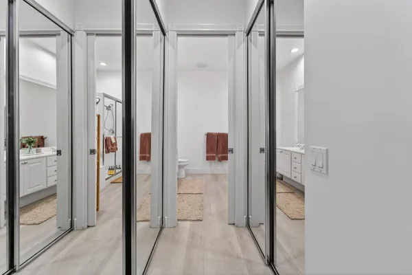 a bathroom with a glass shower door and a glass door