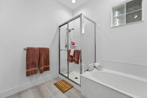 a bathroom with a tub and a shower