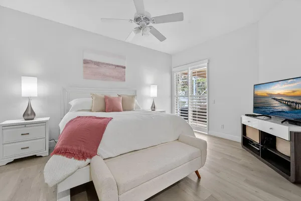 a bedroom with a bed and a flat screen tv