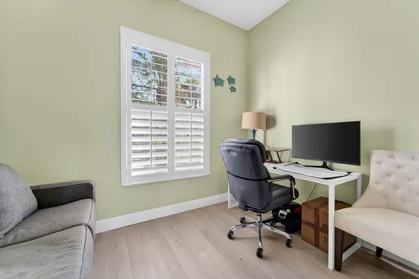 a view of a workspace with furniture and a window