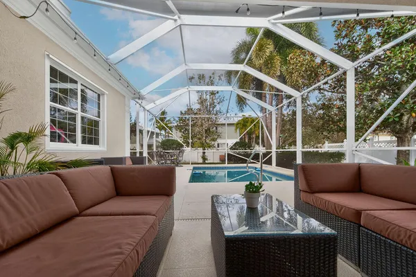 a living room with furniture and large windows