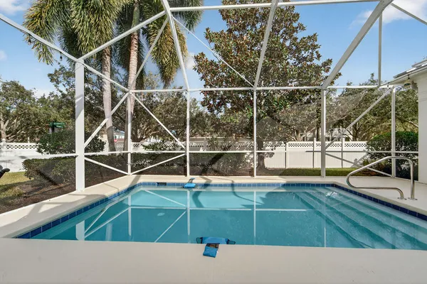 a view of a swimming pool with a chair and table in the patio