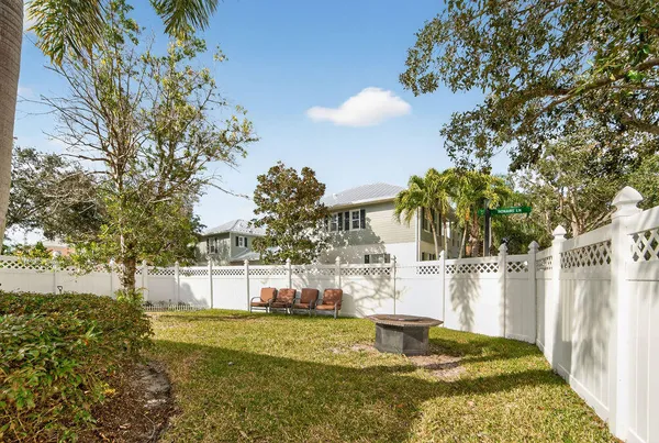 a view of backyard of house with green space