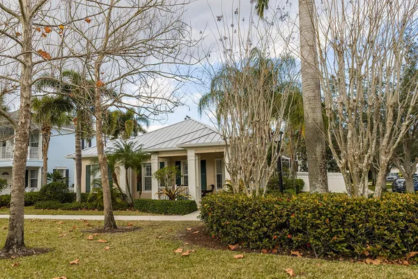 front view of a house with a tree in front