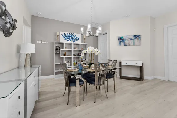 a view of a dining room with furniture and chandelier