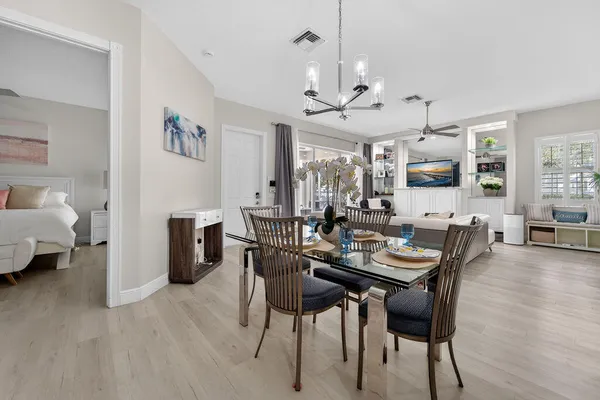 a view of a dining room with furniture and wooden floor