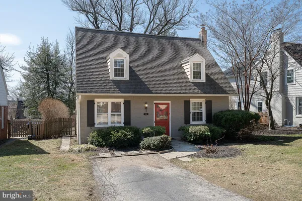 a front view of house with yard and trees around