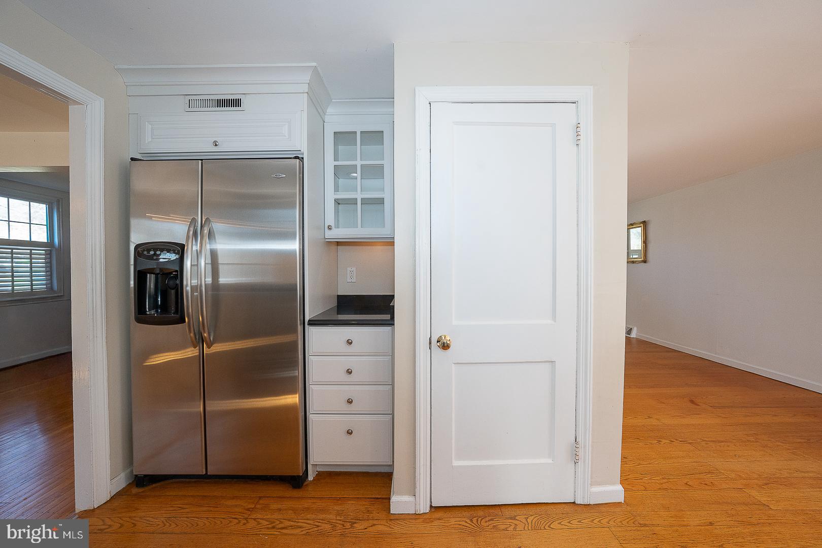 128 Homestead Road Wayne, PA 19087 - Photo 11 of 30 a view of a kitchen with a refrigerator and wooden floor