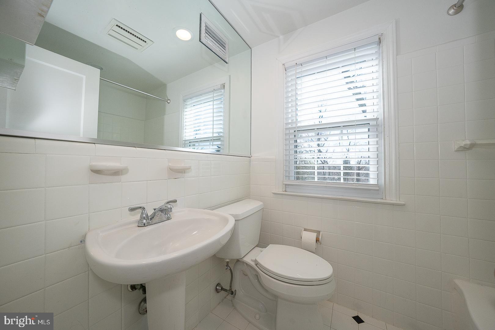 128 Homestead Road Wayne, PA 19087 - Photo 22 of 30 a bathroom with a sink a toilet and a window