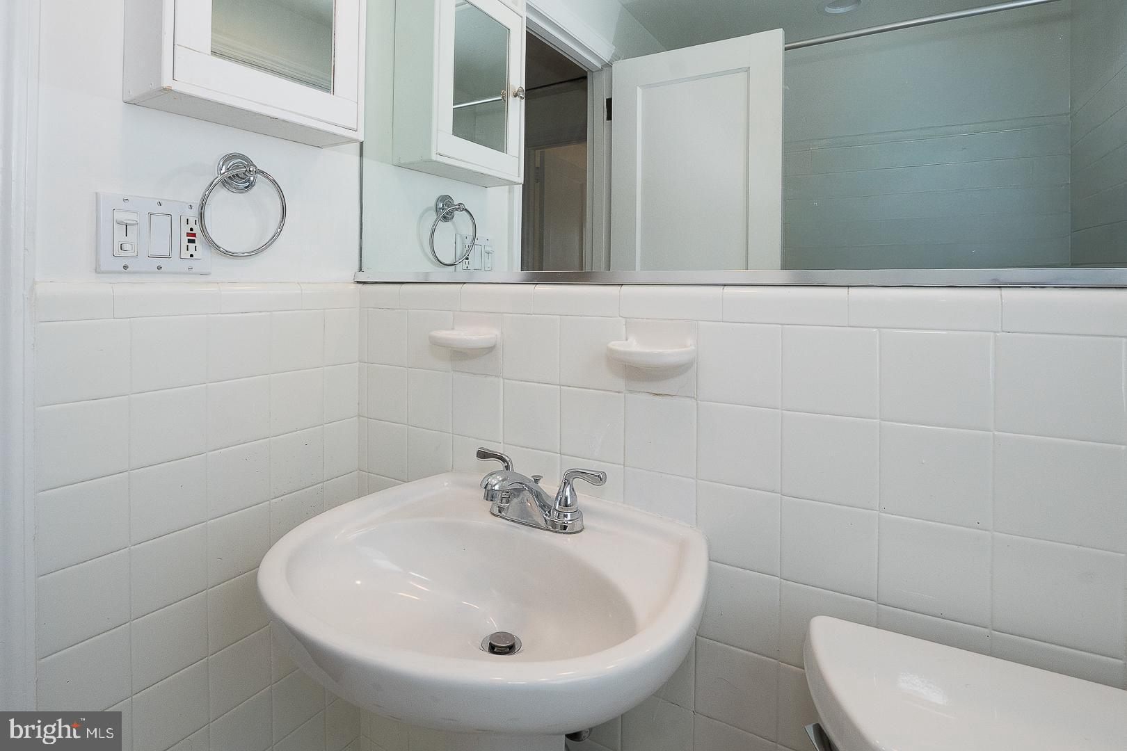 128 Homestead Road Wayne, PA 19087 - Photo 24 of 30 a bathroom with a toilet sink and mirror