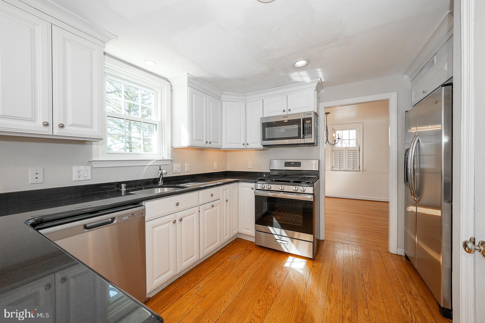 128 Homestead Road Wayne, PA 19087 - Photo 10 of 30 a kitchen with stainless steel appliances granite countertop a stove a sink and a refrigerator