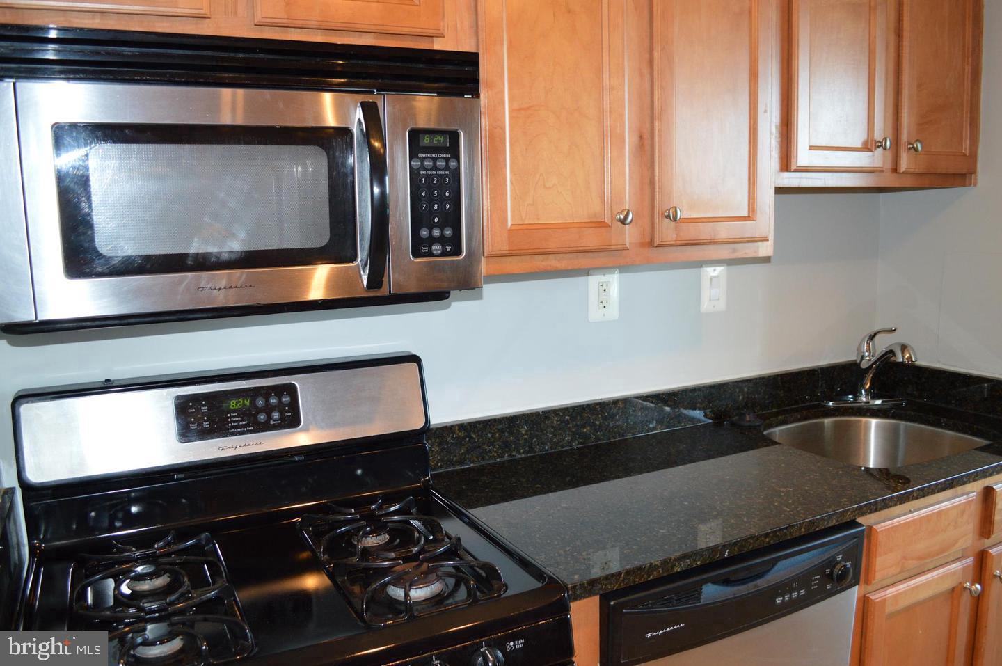 1220 Blair Mill Road, Unit 1007 Silver Spring, MD 20910 - Photo 6 of 27 a kitchen with a stove microwave and sink