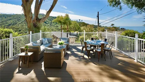 a view of a roof deck with furniture