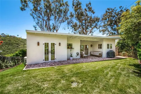 a view of a house with backyard porch and sitting area