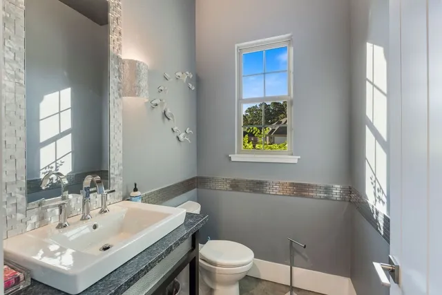 a bathroom with a sink toilet and a mirror