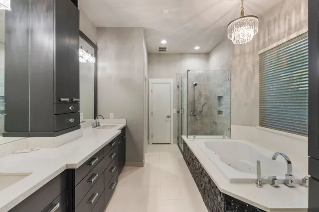 a spacious bathroom with a granite countertop sink a toilet a mirror and shower
